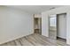 This bright bedroom features modern wood-look flooring and mirrored closet doors at 7521 Reindeer Ct, Las Vegas, NV 89147