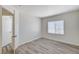 Bright bedroom with wood-look floors, a window, and an open doorway at 7521 Reindeer Ct, Las Vegas, NV 89147