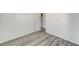 Bright bedroom featuring modern gray wood-look flooring and white walls at 7521 Reindeer Ct, Las Vegas, NV 89147