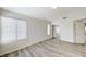 Bright bedroom with wood-look floors, a large window, and a closet with sliding doors at 7521 Reindeer Ct, Las Vegas, NV 89147