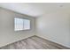 Bedroom featuring modern gray wood-look flooring and a bright window at 7521 Reindeer Ct, Las Vegas, NV 89147