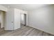 Clean bedroom featuring modern gray wood-look flooring and mirrored closet doors at 7521 Reindeer Ct, Las Vegas, NV 89147