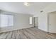 Well-lit bedroom with wood-look floors, neutral walls, and closet with mirrored sliding doors at 7521 Reindeer Ct, Las Vegas, NV 89147