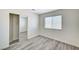 Bedroom with updated gray wood-look flooring and a mirrored closet at 7521 Reindeer Ct, Las Vegas, NV 89147