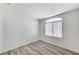 Bright bedroom with modern flooring, neutral walls, and a large arched window at 7521 Reindeer Ct, Las Vegas, NV 89147