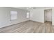 Bedroom with wood floors, neutral walls, and bright windows at 7521 Reindeer Ct, Las Vegas, NV 89147
