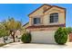 Charming two-story home with a red tile roof, a two-car garage, and desert landscaping at 7521 Reindeer Ct, Las Vegas, NV 89147