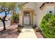 Inviting front entrance showcasing a walkway leading to a double door entry and desert-friendly landscaping at 7521 Reindeer Ct, Las Vegas, NV 89147