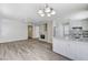 Open-concept kitchen and living area with a fireplace, updated appliances, and wood floors at 7521 Reindeer Ct, Las Vegas, NV 89147