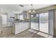 Eat-in kitchen with white cabinets, stainless appliances, and a view of the pool at 7521 Reindeer Ct, Las Vegas, NV 89147
