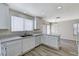 Bright kitchen featuring white cabinets, countertops, and stainless steel sink at 7521 Reindeer Ct, Las Vegas, NV 89147