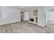 Open living space with a fireplace, wood floors, and access to multiple rooms at 7521 Reindeer Ct, Las Vegas, NV 89147