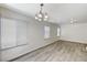 Bright living area featuring new light fixtures, wood floors, and neutral paint at 7521 Reindeer Ct, Las Vegas, NV 89147