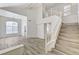 Bright living room showcasing an open floor plan, high ceilings, staircase, and neutral-toned flooring at 7521 Reindeer Ct, Las Vegas, NV 89147