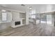 Open-concept living space featuring a fireplace, wood flooring, and access to the kitchen and pool area at 7521 Reindeer Ct, Las Vegas, NV 89147