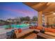 A backyard with a pool, slide, and ample seating area for outdoor entertainment at 7670 Frittata Ave, Las Vegas, NV 89113