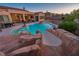 An inviting backyard pool featuring a slide and comfortable lounge area at 7670 Frittata Ave, Las Vegas, NV 89113
