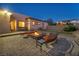 An outdoor patio featuring a cozy fire pit and comfortable seating area at 7670 Frittata Ave, Las Vegas, NV 89113