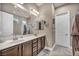 Elegant bathroom featuring dual sinks, granite countertops, and a separate shower area at 7670 Frittata Ave, Las Vegas, NV 89113