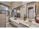 Stylish powder room with modern vanity, contemporary fixtures and a decorative mirror at 7670 Frittata Ave, Las Vegas, NV 89113