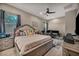 Comfortable bedroom features a ceiling fan, dual windows and a relaxed ambiance at 7670 Frittata Ave, Las Vegas, NV 89113