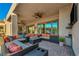 A spacious covered patio featuring comfortable seating and views of the backyard at 7670 Frittata Ave, Las Vegas, NV 89113
