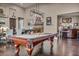 Game room boasts a billiards table adjacent to a bar and dining area at 7670 Frittata Ave, Las Vegas, NV 89113