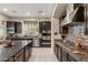 Spacious kitchen with stainless steel appliances, granite counters, island, and ample cabinet space at 7670 Frittata Ave, Las Vegas, NV 89113