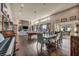 Open living area with hardwood floors and stone fireplace. Features pool table and dining area at 7670 Frittata Ave, Las Vegas, NV 89113