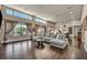 Bright, open living room features high ceilings, clerestory windows, and a modern sectional sofa at 7670 Frittata Ave, Las Vegas, NV 89113
