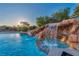 Luxurious pool featuring a captivating rock waterfall and grotto, offering a serene backyard retreat at 7670 Frittata Ave, Las Vegas, NV 89113