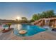 A backyard pool featuring a rock waterfall, grotto and in-pool seating area, perfect for relaxation at 7670 Frittata Ave, Las Vegas, NV 89113