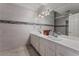 Bright bathroom featuring double sinks, white countertops, stylish lighting and a decorative tiled backsplash at 7720 W Agate Ave, Las Vegas, NV 89113