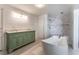 Beautiful bathroom featuring a marble walk-in shower, an oversized soaking tub and dual sinks at 7720 W Agate Ave, Las Vegas, NV 89113