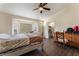 Comfortable bedroom with natural light from large bay window, wooden floors, and walk in closet at 7720 W Agate Ave, Las Vegas, NV 89113
