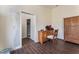 Bedroom featuring hardwood floors, natural lighting, and wooden desk with chair at 7720 W Agate Ave, Las Vegas, NV 89113