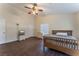A spacious bedroom features wood-look floors, a ceiling fan, and ample space at 7720 W Agate Ave, Las Vegas, NV 89113