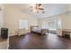 A spacious bedroom features wood-look floors, a ceiling fan, and a large window at 7720 W Agate Ave, Las Vegas, NV 89113