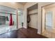 Bedroom with hardwood flooring, connecting doors to closet and bathroom, and bright window view at 7720 W Agate Ave, Las Vegas, NV 89113
