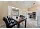 A dining room features a large window, tile floors, and access to the kitchen at 7720 W Agate Ave, Las Vegas, NV 89113