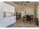 An open dining area with tile floors and a dining table next to the kitchen at 7720 W Agate Ave, Las Vegas, NV 89113