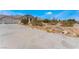 Wide view showcases an expansive driveway leading to a charming single-story home at 7720 W Agate Ave, Las Vegas, NV 89113