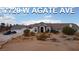Expansive single-story home with desert landscaping, multiple-car garage, and grand entrance, bathed in natural light at 7720 W Agate Ave, Las Vegas, NV 89113