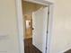 An open doorway reveals the spacious hallway with wood-look flooring at 7720 W Agate Ave, Las Vegas, NV 89113