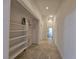 Hallway with tile floors and an open closet with shelves at 7720 W Agate Ave, Las Vegas, NV 89113