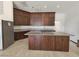 Spacious kitchen features wooden cabinets, center island and stainless steel appliances at 7720 W Agate Ave, Las Vegas, NV 89113