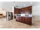Open kitchen features stainless steel appliances, wooden cabinets, and center island at 7720 W Agate Ave, Las Vegas, NV 89113
