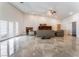 Bright living room featuring a fireplace, vaulted ceilings, and double french doors with neutral decor at 7720 W Agate Ave, Las Vegas, NV 89113