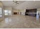 Large living space with tile floors, vaulted ceilings, and adjacent kitchen area with modern appliances at 7720 W Agate Ave, Las Vegas, NV 89113