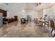 Open living room with light tile floors next to dining area with an abundance of natural light at 7720 W Agate Ave, Las Vegas, NV 89113